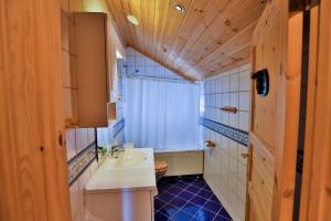 a small bathroom with a sink and a toilet at Grand Log Cabin with Fireplace and 12-14 Beds in Beitostøl +26 photos
