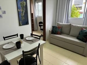 a living room with a table and a couch at Cantinho do Mané in Florianópolis