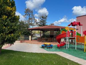 a playground with a slide in a yard at Apartment Sunny Seasons Byala in Byala