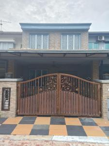 a wooden gate in front of a house at Elly Homestay Shah Alam in Shah Alam