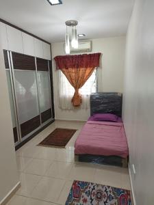 a small bedroom with a bed and a window at Elly Homestay Shah Alam in Shah Alam +7 photos