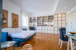 a bedroom with a bed and a table and chairs at Vatican Museum apartment by Varental in Rome +44 photos