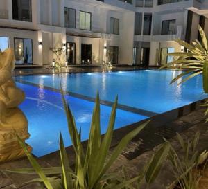 a large swimming pool with blue water in a building at Imperial Beach Resort in Hurghada +1 photo