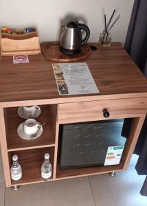 a wooden table with a laptop on top of it at Elephant Boutique Lodge in Tswinga