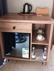 a wooden table with a tea kettle on top of it at Elephant Boutique Lodge in Tswinga +17 photos