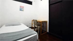 une chambre avec un lit, une table et une chaise dans l'établissement Posada Botero, à San Andrés