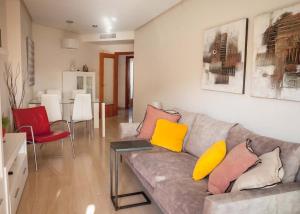 a living room with a couch with colorful pillows at Apartamento Marmara in Jávea