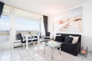 a living room with a couch and a table at TimmenKoje App 290 in Timmendorfer Strand