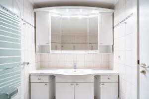 a white bathroom with a sink and a mirror at TimmenKoje App 290 in Timmendorfer Strand +16 photos