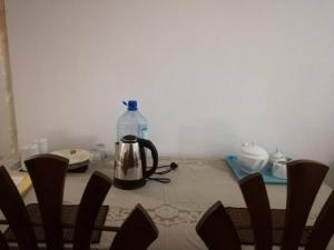 a tea kettle sitting on a table with a bottle of water at Villa 133 - 2 bed rooms in Dodanduwa