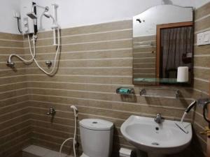 a bathroom with a toilet and a sink and a shower at Villa 133 - 2 bed rooms in Dodanduwa +22 photos