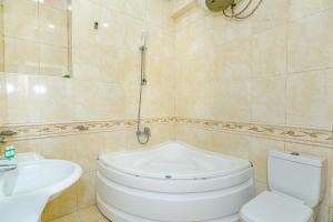 a bathroom with a white toilet and a sink at Sweet Apartment in Nizami in Baku