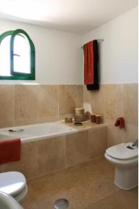 a bathroom with a tub and a toilet and a sink at Hotel Apartamentos Manilva Sun in Manilva