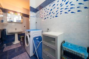 a bathroom with a washing machine and a sink at Villa Verde - 300m From Sea in Bordighera +18 photos