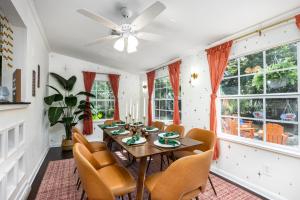 a dining room with a table and chairs at 4bd Gator Grove Villa - Backyard - Games - Near UF in Gainesville