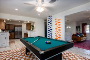a living room with a pool table in it at 4bd Gator Grove Villa - Backyard - Games - Near UF in Gainesville