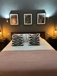 a bedroom with a bed with three pillows on it at Basement apartments in San Bartolomé de Tirajana