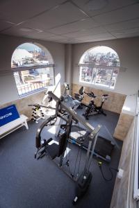 a gym with two bikes in a room with two windows at Hotel Almería in Salta