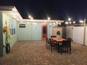 a room with a table and chairs and lights at Muse by the Shore in Clearwater Beach