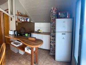 a small kitchen with a table and a refrigerator at Departamento Céntrico San Martin de los Andes in San Martín de los Andes +6 photos
