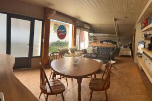 a living room with a table and chairs at Departamento Céntrico San Martin de los Andes in San Martín de los Andes