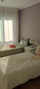 a bedroom with two beds next to a window at Calm House in Arona