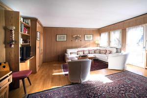 a living room with a couch and a table at Homeby, Casa Due Vette in Cortina dʼAmpezzo