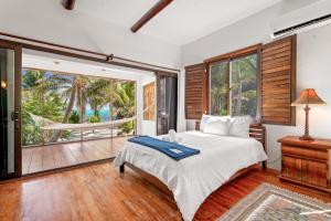 a bedroom with a bed and a hammock on a porch at La Perla del Caribe - Villa Amber in San Pedro