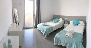 a hotel room with two beds and a window at TURQUESA 1 e TURQUESA 2 Fuerteventura in La Oliva +121 photos