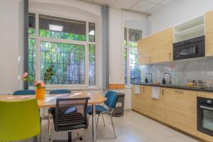 a kitchen with a table and chairs in a room at Grassalkovich Residence in Budapest