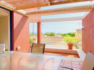 a table and chairs on a patio with a view at Barbati Alpha MiniVilla by DadoVillas in Barbati