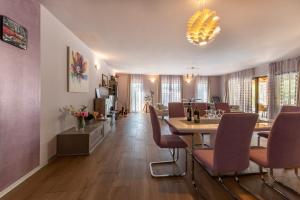 Una sala de estar con una mesa de comedor y sillas. en Villa Volmera, en Banjole