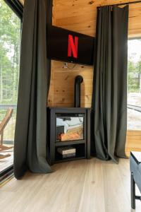 Μια τηλεόραση ή/και κέντρο ψυχαγωγίας στο Modern Treehouse! Cozy Hot Tub, Views & Firepit!