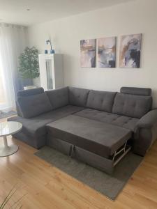 a living room with a gray couch and a table at Parkside apartment in Nitra