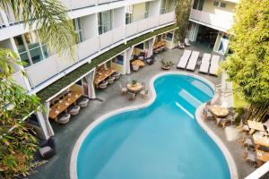 an overhead view of a pool at a hotel with tables and chairs at Avalon Hotel Beverly Hills, a Member of Design Hotels in Los Angeles