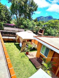 a small house with a tent in the yard at Posada Amatenco & Spa Tepoztlán in Tepoztlán