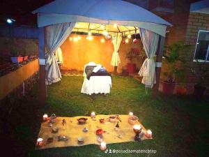 a backyard with a bed and a tent with candles at Posada Amatenco & Spa Tepoztlán in Tepoztlán