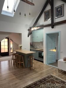 a kitchen with a table and chairs in a room at Casa Toma M in Baia Mare