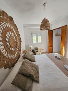 a bedroom with a large bed with a large mirror at La huerta del Castillo con su Caz de agua - Enjoy Life & Relax in Castillo de Locubín