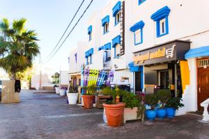 a street with potted plants in front of a building at Mouja Taghazout in Taghazout