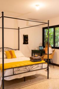 a bedroom with a black canopy bed and a desk at CASA VALPARAISO Suites in Saltillo
