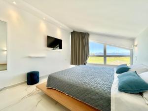 a bedroom with a bed and a large window at Danune Luxury Beachfront Villa with private pool by DadoVillas in Astrakeri +23 photos