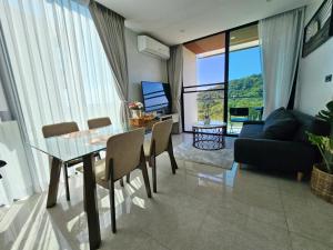 a living room with a glass table and a couch at The viva patong condo C601 in Patong Beach