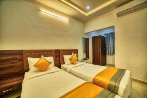 two beds in a hotel room with twoermottermott at Hotel Visa Inn 4kms from Airport l Free Airport pickup & drop 24x7 in Bengaluru +11 photos