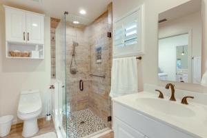a bathroom with a shower and a sink and a toilet at Pet-Friendly Fort Pierce Home with Screened Porch! in Fort Pierce +18 photos