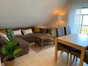 a living room with a couch and a table at Haus-am-See-Kolktstr-1-OG-links in Norddeich