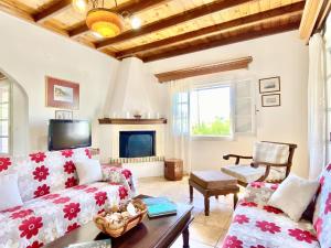 a living room with a couch and a fireplace at Kostas Beach Estate with private pool by DadoVillas in Astrakeri