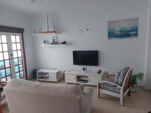 A television and/or entertainment centre at Casa La Palmera