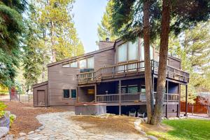 a large wooden house with a tree at A Slice of Silver Fir in Truckee