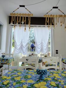 a dining room with white chairs and a table at Costa Costa Rooms in Sant'Egidio del Monte Albino +36 photos